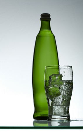 Purified mineral water on the wet glass desk with reflectionの写真素材