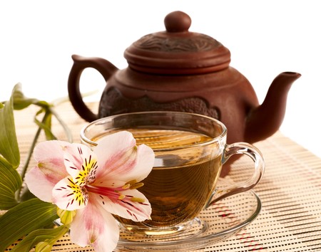 Cup of green tea on the table with orchid flowerの写真素材