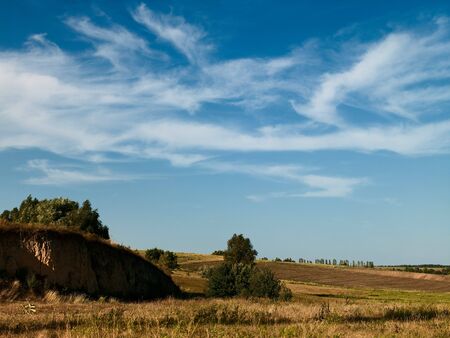 autumn hills under the blue skies with cloudsの写真素材