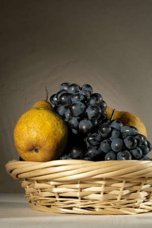 fresh tasty fruit in the bast basket  still-lifeの写真素材