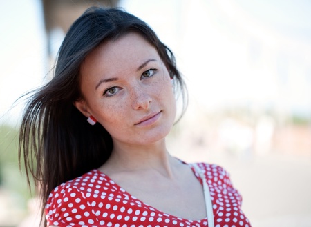 Beauty young woman on the bridge with unfocused people on backgroundの写真素材