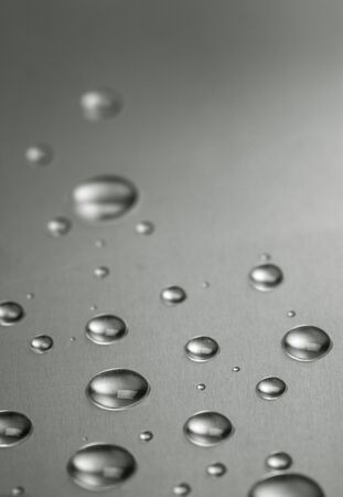 Quicksilver. Abstract still-life with liquid droplets over steel surfaceの写真素材