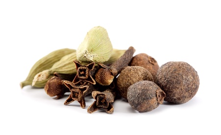 closeup of cloves, cardamon and allspice over white backgroundの写真素材