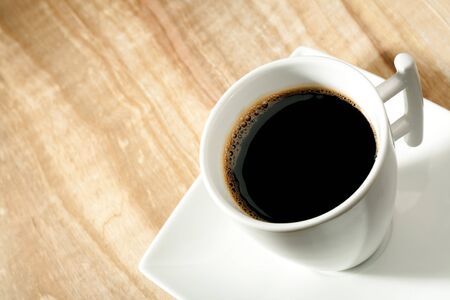 coffee cup over wooden deskの写真素材