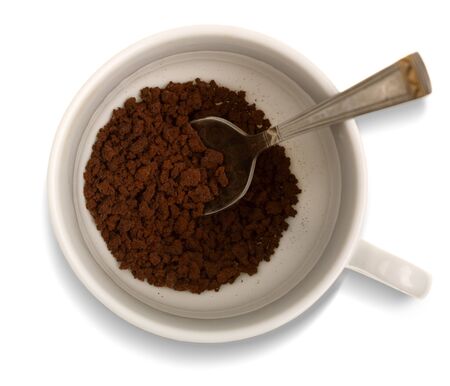 White cup with instant coffee granules. View from above with clipping pathの写真素材