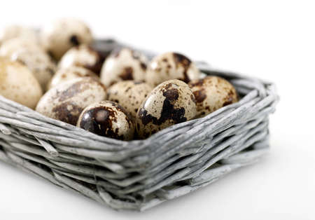 Quail eggs into the wicker basketの写真素材