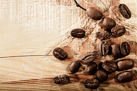 Coffee beans over wooden desk, abstract backgroundsの写真素材