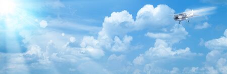 Blue skies with bright sun and airplane as abstract backgroundsの写真素材