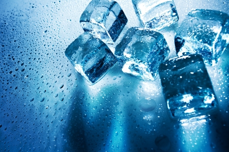 Ice cubes over wet backgrounds with back lightの写真素材