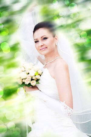 Happy dancing young wife. Female outdoor portrait against abstract natural backgroundsの写真素材