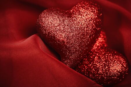 abstract Valentine's backgrounds over red textile with tho heartsの写真素材