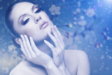 Beauty. Female outdoors portrait with floral backgroundsの写真素材