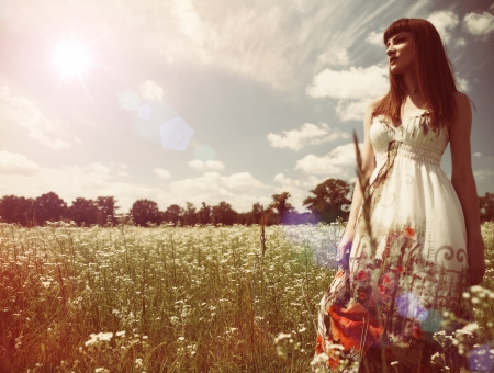 Beauty young woman walking around the summer meadowの写真素材