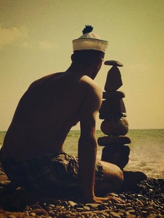 On the beach. Retro stylized post card with old cardboard texture for your designの写真素材