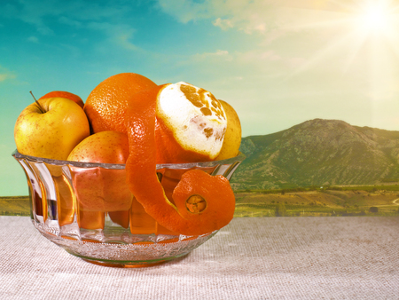Natural food still life. Bowl with fresh fruits on the deskの写真素材