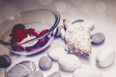 Bathroom still-life with candles, pebble and rose petalsの写真素材