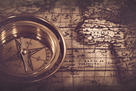 Old nautical compass over the map, abstract retro still lifeの写真素材