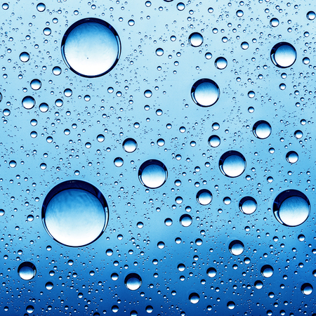 Pure oil drops over glass surface as abstract backgroundsの写真素材