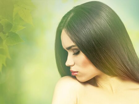 Fashionable female portrait over natural green backgrounds. Vogue style brunette girl.の写真素材
