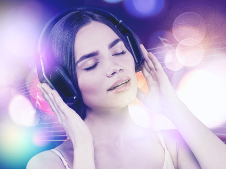 Beauty young girl hearing music with headset, female portraitの写真素材