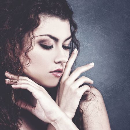 Fashionable female portrait over grungy backgrounds. Vogue vamp style brunette girl.の写真素材
