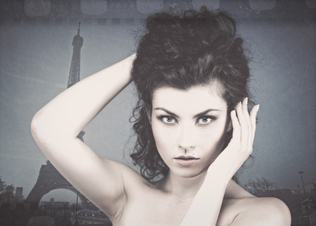 Grungy female portrait. Young beauty against Eiffel Towerの写真素材