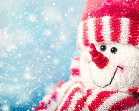 Funny snowman portrait against snowfall, abstract christmas backgroundsの写真素材