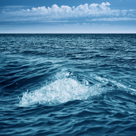 Abstract marine view with ocean waves, water surface and blue skyの写真素材