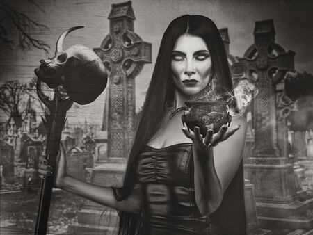 Halloween backgrounds with witch woman and spooky cemeteryの写真素材