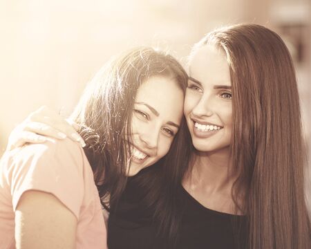 Friendship, couple of young girls smiling , female urban portraitの写真素材