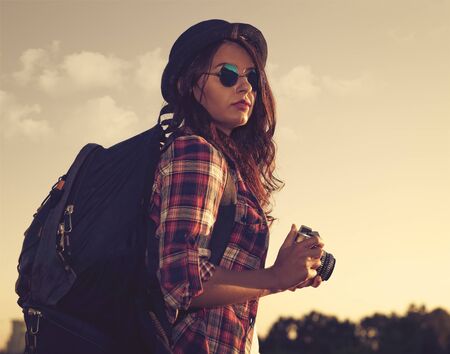 Young beauty hiker walking outdoors with retro photo camera, female lifestyle portraitの写真素材