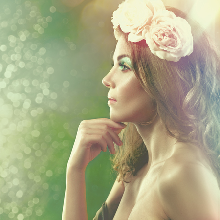 Spring Beauty. Female portrait with floral crown and beauty natural bokehの写真素材