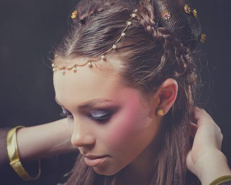 Retro style female portrait against dark backgroundsの写真素材