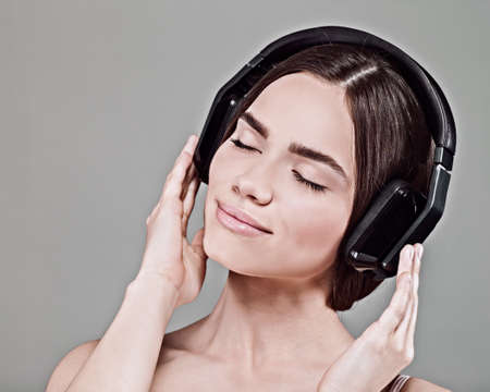 Music. Beauty young adult woman listen music with headsetの写真素材