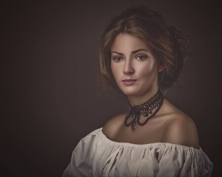 Grungy female portrait. Retro styled classic dramatic lightの写真素材