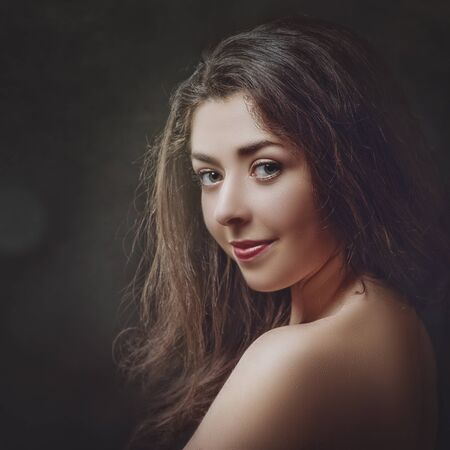 Grungy female portrait. Retro styled classic dramatic lightの写真素材