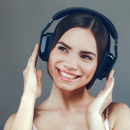 Music. Beauty young adult woman listen music with headsetの写真素材