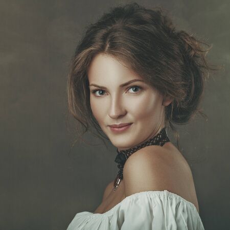 Grungy female portrait. Retro styled classic dramatic lightの写真素材