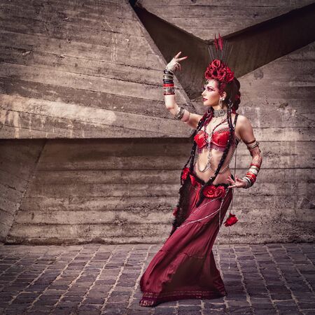 Tribal dancer moving and dancing outdoors against urban backgroundsの写真素材