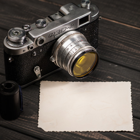 October 23, 2017, Kiev, Ukraine. Still life with retro soviet photo camera FED-2 and lens Industar over wooden deskのeditorial素材