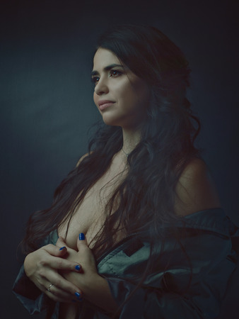 Beautiful plus size model posing at camera, dramatic female portraitの写真素材