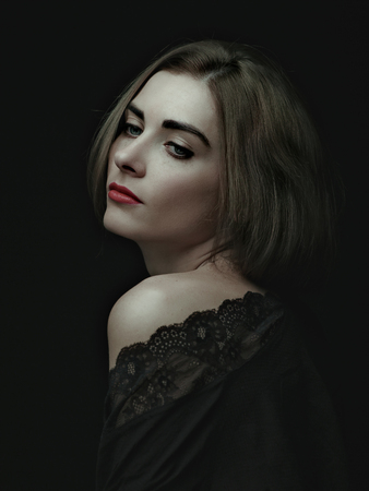 Dramatic female portrait against dark backgroundsの写真素材