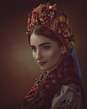Ethno Beauty. Beautiful young woman in traditional ukrainian dress and crownの写真素材