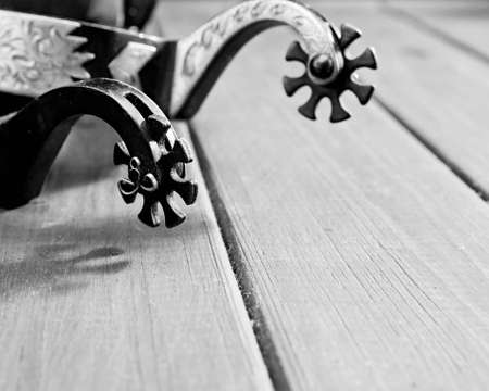 Retro still life. Spurs over vintage wooden deskの写真素材