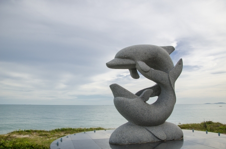 Dolphin sculpture on the beachの写真素材