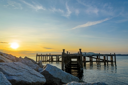 Old bridge with sun rise behind, in east of Thailandの写真素材