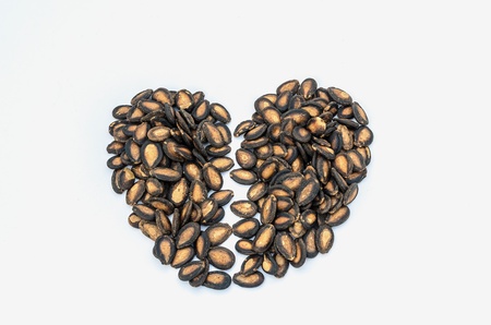 Broken heart from pumpkin seed arrangement