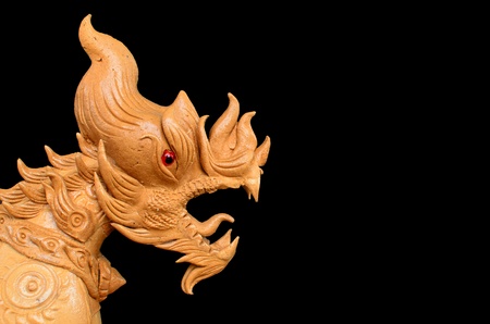 Thai style lion head carving isolated on blackの写真素材