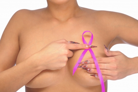 Female controlling breast for cancer with pink ribbon isolated on whiteの写真素材