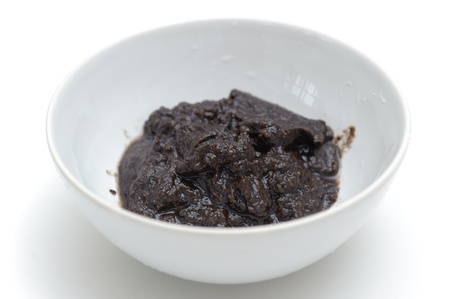 Grated champignon in the bowl over white